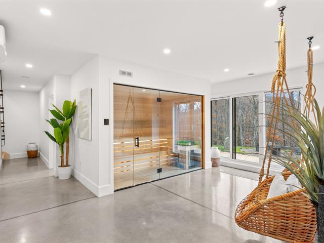 Outdoor sauna at 6 AM, steam rising, snow around it